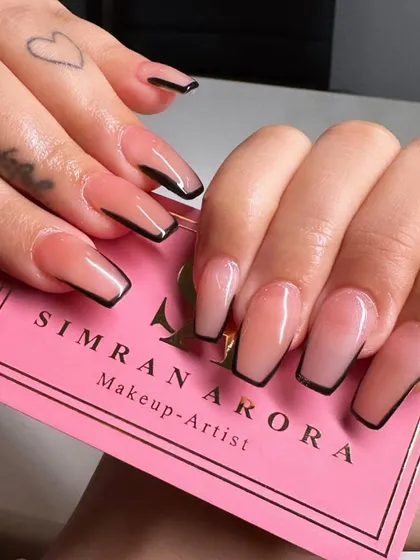 A close-up of the modern outlined French manicure, showcasing the clean lines and glossy finish.