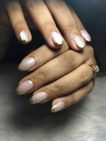 A modern twist on a classic. This look features a clean, natural base with a striking gold chrome French tip. It's an elegant and sophisticated design that shows how a small detail can make a huge impact, perfect for when you want your nails to look effortlessly chic.