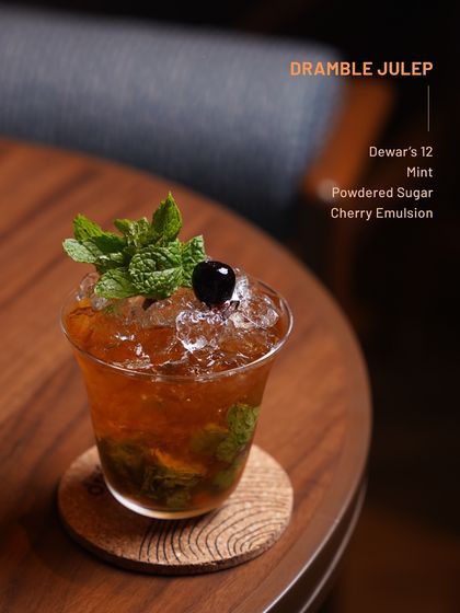A refreshing Dramble Julep from our Dewar's 12 series. This easy-sipping cocktail blends mint, cherry, and powdered sugar for a bright and balanced drink.