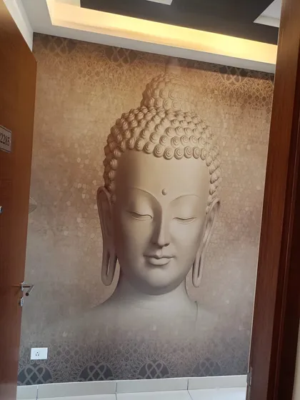 A serene 3D-effect Buddha mural installed in a living area. This type of custom wallpaper adds a peaceful and spiritual focal point to the room, and I make sure the placement is centered for maximum impact.