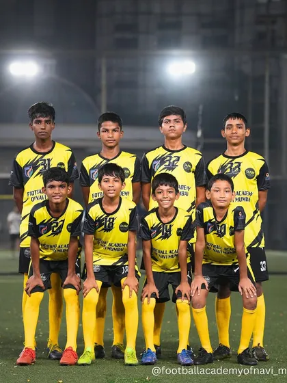 Our youth team stands united for a group photo during a night training session. The grind continues under the lights as they work to build their skills and team chemistry.