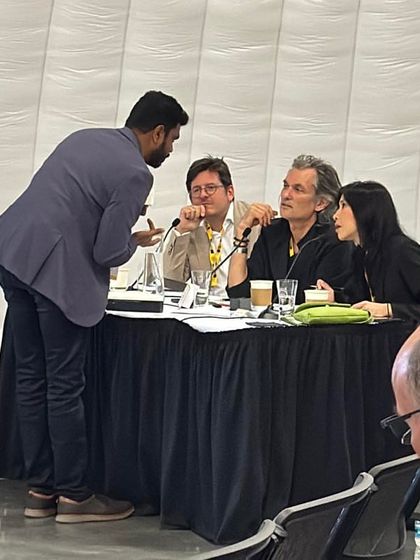 A juror at WAF engages with an architect during a presentation. These interactions are crucial, and I document them to provide a complete picture of the judging process at the festival.