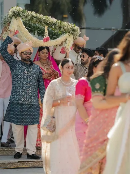 A beautiful shot of the bridal procession, with guests looking on. We choreograph these moments to feel both grand and deeply personal.