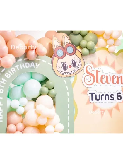 A detailed shot of the personalized "Steven Turns 6" sign on the Labubu backdrop.