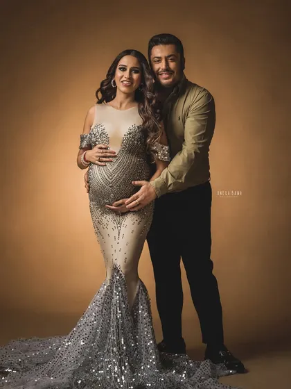 Glamour and love combined. This couple's portrait showcases a stunning gown while highlighting the supportive and loving relationship between the partners.