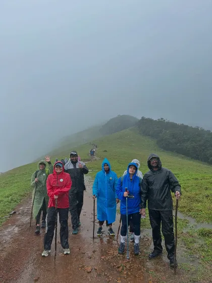 Geared up and ready to go. Our group trekking along a muddy path on the Kudremukha trail, with mist adding to the atmosphere.