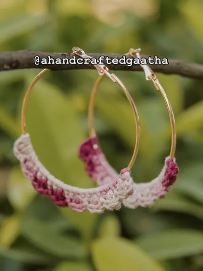 A product shot of the maroon hoops in a natural setting. The deep, warm tones are perfect for festive occasions or adding a touch of luxury.