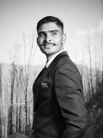 A handsome groom's portrait in black and white. This style adds a classic, cinematic quality to the shot.