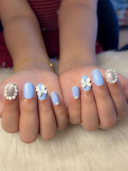 A full view of the perfectly symmetrical coquette nail art.