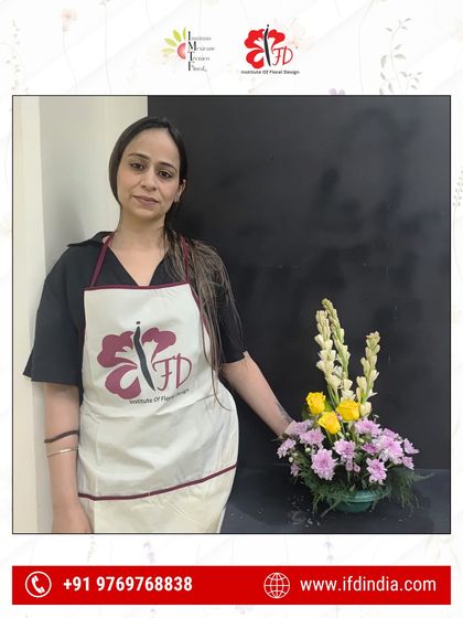The journey begins with a single stem. This new student proudly presents her first floral piece, a foundational exercise in creating structure and visual flow in an arrangement.
