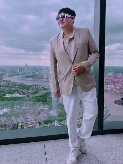 Another pose against the London skyline, showing how a well-fitted blazer can create a sharp silhouette.