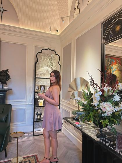 A side profile of the dusty rose dress, showing its flattering silhouette and halter neckline.