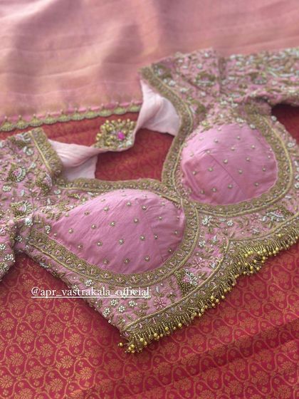 A pink blouse with padded cups and all-over floral embroidery.