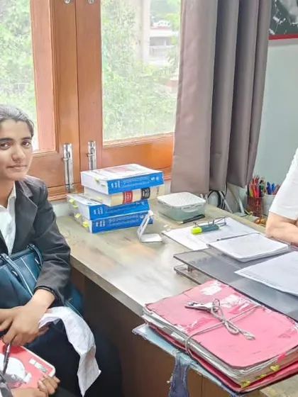 A discussion with law interns in my office, surrounded by case files and law books. This is where the real learning happens, by engaging with real-world problems.