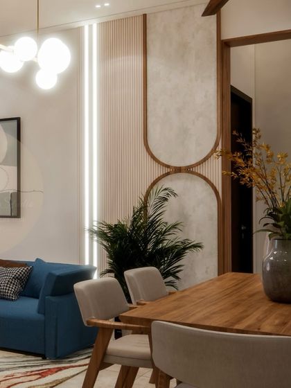 Details from our Prestige Waterford project, showing the blend of textures and shapes. The fluted wall panels, curved design elements, and modern lighting work together to create a cohesive and visually interesting living and dining space.