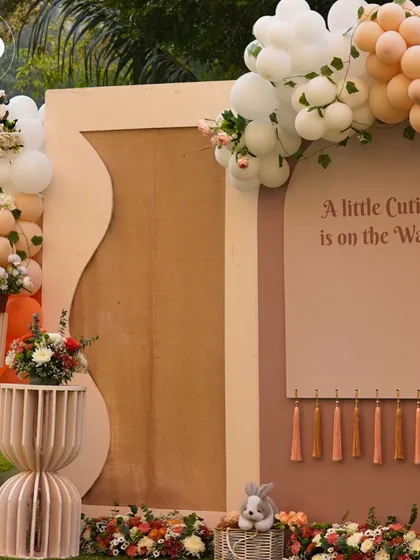 The main backdrop for a 'Little Cutie' themed baby shower, featuring soft pastel colors and modern shapes. The custom sign and tassel details added a touch of boho-chic elegance to the outdoor setting.