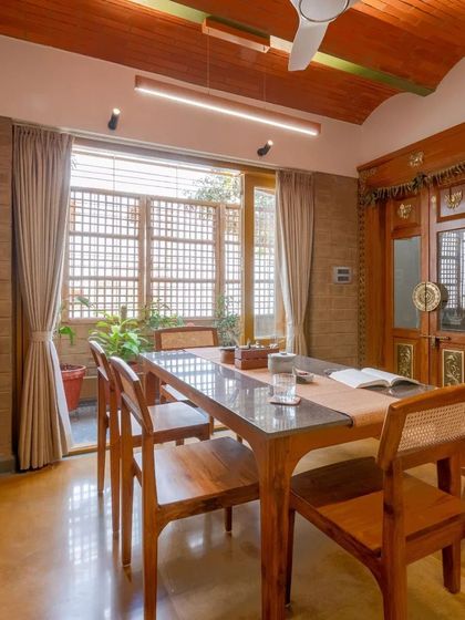 The dining area, featuring a custom wooden table and an antique door, which adds a layer of history and character to the home.