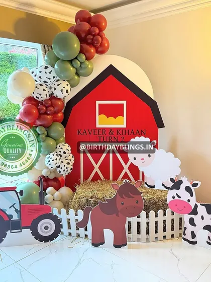 A fun and colorful farm animal theme, complete with a red barn backdrop, hay bale, and cute cutouts of a horse, cow, and sheep. The tractor cutout adds a great touch for little vehicle lovers.