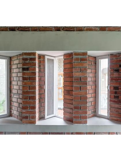 A detail of the skewed windows on the eastern and western facades of the ASA office. This angular placement is a specific passive design strategy to cut the harsh glare of the sun while still allowing for daylight and fresh air.