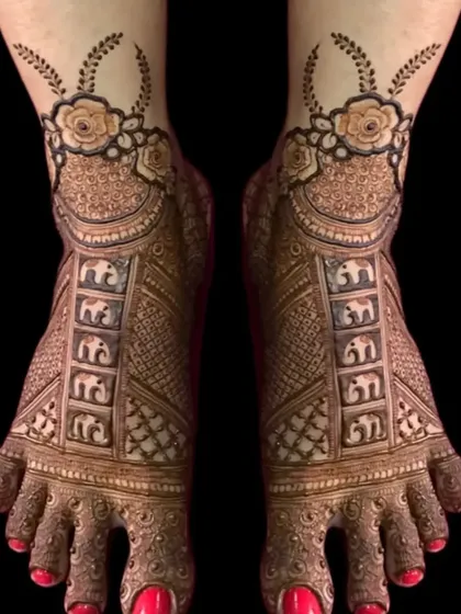 This bridal foot mehandi features rows of tiny elephants, a floral ankle band, and detailed work on the toes.