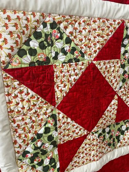 A close-up view of the beginner star quilt, highlighting the precise points and fabric combinations.