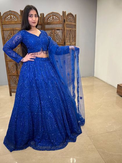 A confident pose in the royal blue lehenga, a perfect example of the show-stopping party wear you can find in my pre-loved collection.
