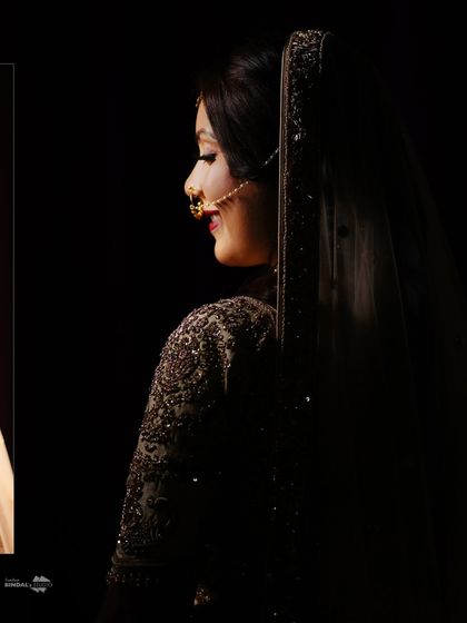 A moody and artistic portrait of the bride. The low-key lighting and her serene expression create a very cinematic and elegant feel.