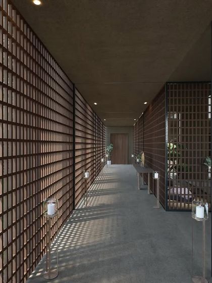 The screened corridor of The Sanctuary in Hyderabad. The entire wall is a delicate lattice of wood, creating a beautiful, rhythmic pattern of light and shadow that guides you through the space.