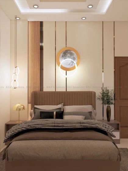 A bedroom with a warm, neutral color palette, featuring a moon-themed light fixture and modern pendant lights.