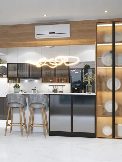 This open-concept parallel kitchen is designed for modern living, featuring a stylish breakfast bar with comfortable seating. The design includes a full-height glass crockery unit with internal lighting, showcasing how we blend high functionality with beautiful display solutions.