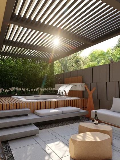 Sunlight filters through the pergola of a hotel suite's private patio. The design balances sun and shade, creating a comfortable and visually dynamic space for relaxation at any time of day.