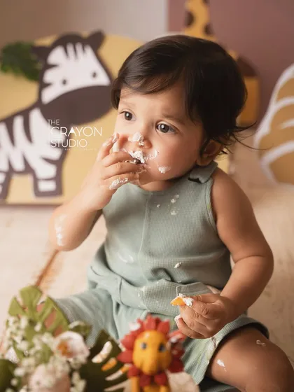 Getting right into it. This close-up captures the messy, delicious fun of a first birthday cake smash.