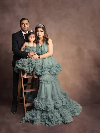 A formal family portrait where mother and daughter are dressed like royalty. The elegant gowns and classic pose create a truly timeless and stunning image.
