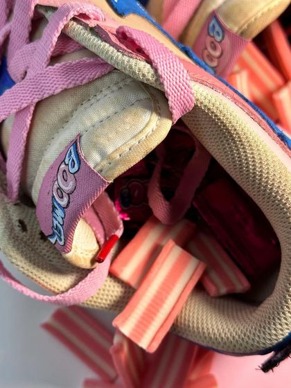 A fun detail shot of the Boomer custom Dunks, filled with bubblegum. The tongue tag is also custom-painted with the Boomer logo.