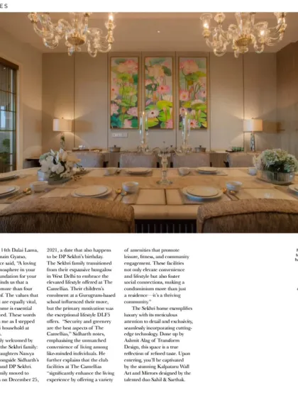 The dining room of the Sekhri residence, featured in a magazine. The space is defined by a long table set for a gathering, beautiful floral artwork, and twin crystal chandeliers that add a touch of grandeur.
