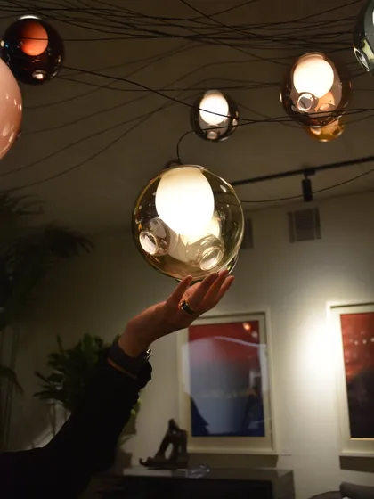 The tactile nature of the Bocci 28 pendant is highlighted here. Each piece is a substantial, hand-blown glass sphere, inviting a closer look at its internal complexity.