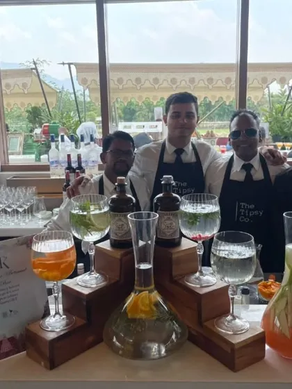 Our professional bartending crew posing at a stunning venue. We are ready to craft bespoke gin and tonics and other signature cocktails for the celebration.
