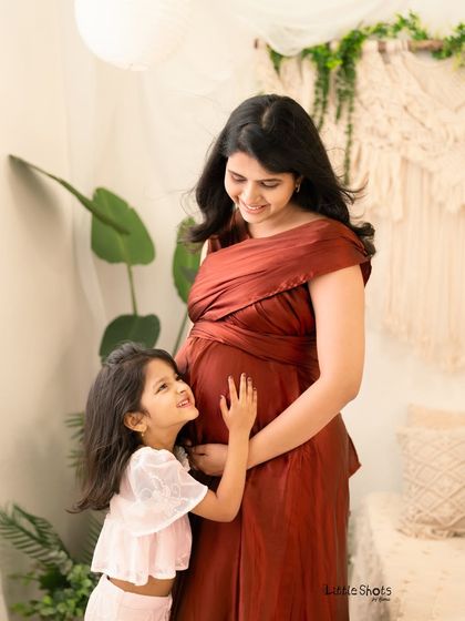 The look of pure adoration from a daughter to her expectant mother. This candid moment was captured during a maternity session, showing the special connection as the family prepares to welcome a new member.