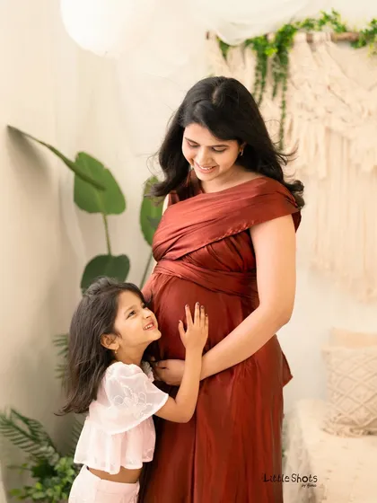 The look of pure adoration from a daughter to her expectant mother. This candid moment was captured during a maternity session, showing the special connection as the family prepares to welcome a new member.