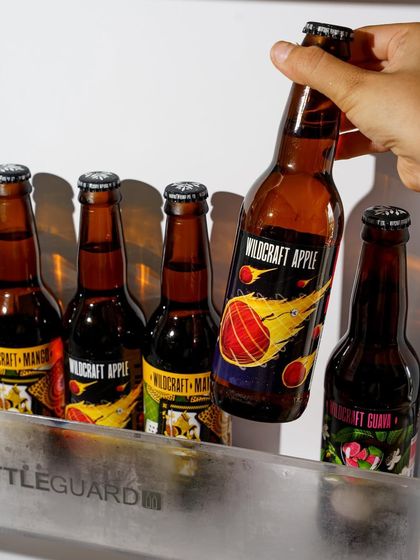 This shot for Wildcraft Beverages captures the moment of grabbing a cold drink from the fridge. The condensation and hard light create a feeling of refreshment, making it a powerful lifestyle image for a beverage brand.