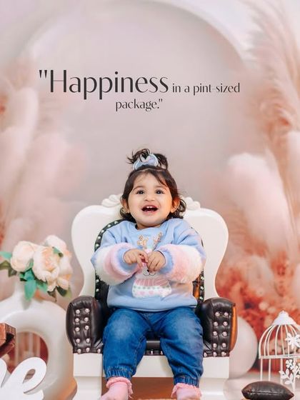 Happiness in a pint-sized package. This joyful first birthday photo was taken in our studio against a beautiful pampas grass backdrop.