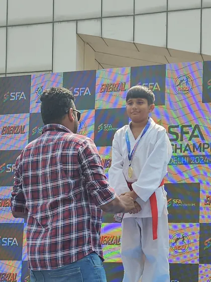 A father congratulating his son on the podium. Moments like these are what our karate family is all about.