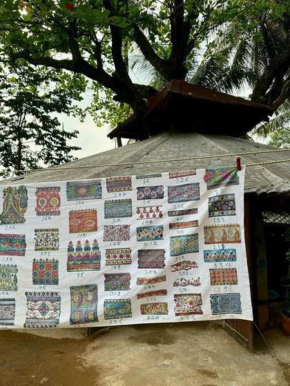 A textile sheet displaying dozens of our vintage border prints, hung to dry in our garden studio. This is a beautiful showcase of the history and variety held within our extensive block archive.