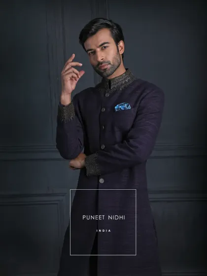 Wrapped in the richness of dark wine handloom silk, this achkan tells a story of timeless Indian regality. The jewel-like embroidery and antique metallic buttons whisper of our heritage.