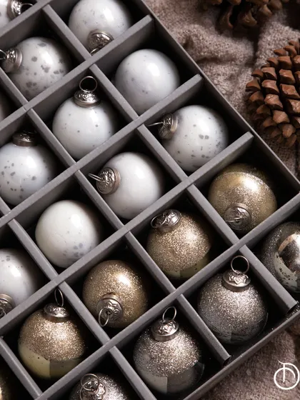My Christmas baubles come beautifully arranged in a gift box, making them a perfect present or an easy way to store your treasured ornaments. The mix of glittery gold and snowy white adds a touch of holiday magic.