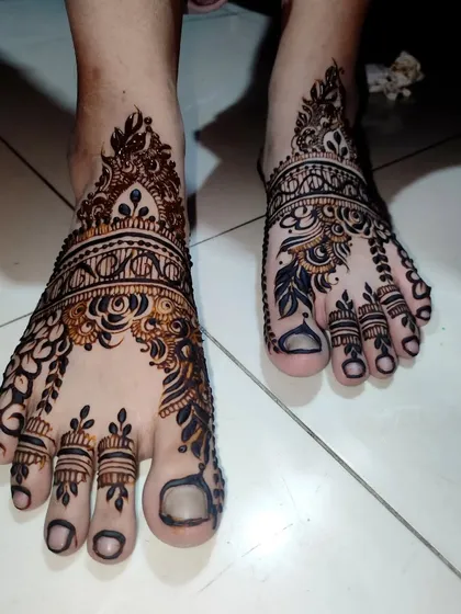 A beautiful and intricate design for the feet, perfect for any special occasion. The dark tips on the toes are a classic touch.