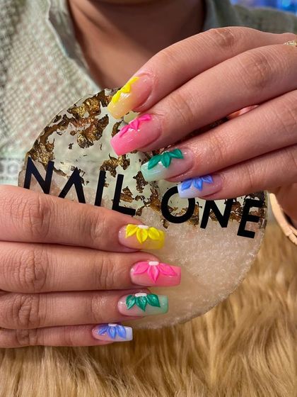 We love creating bold, 3D floral designs. This set features individually sculpted flowers in a rainbow of colors on each nail, creating a vibrant, textured look that is perfect for summer.