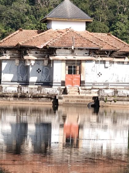 The reflection of the Varanga lake temple in the still water, a picture of perfect symmetry and peace.