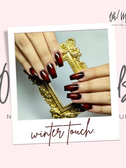 Cold hands, bold nails. This winter design features a striking red and black ombre on long, coffin-shaped nails for a dramatic and moody look.