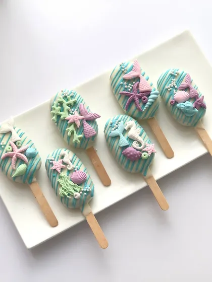 My dessert tables are not complete without some matching treats. These mermaid-themed cakesicles are decorated with handcrafted tails, starfish, and shells to match the main cake.
